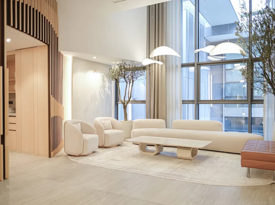 MedArtHair patient lounge with white seating and floor-to-ceiling windows